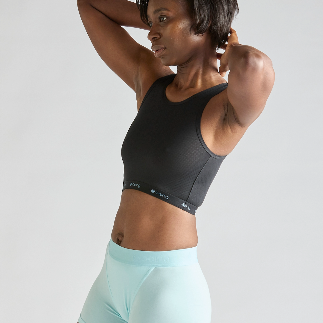 Person wearing the Being Wear Smoothing Crop, a lightweight chest-support top with adjustable side fastenings.
